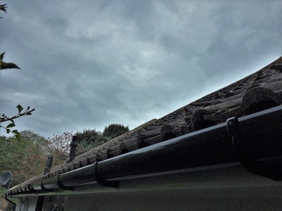 White fascia and soffit with black deep flow half round guttering UPVC