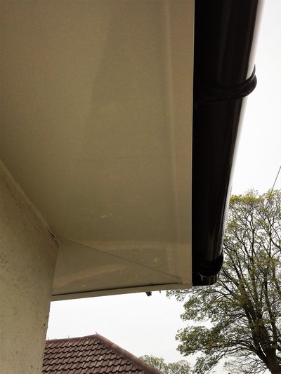 White fascia and soffit with black deep flow half round guttering UPVC