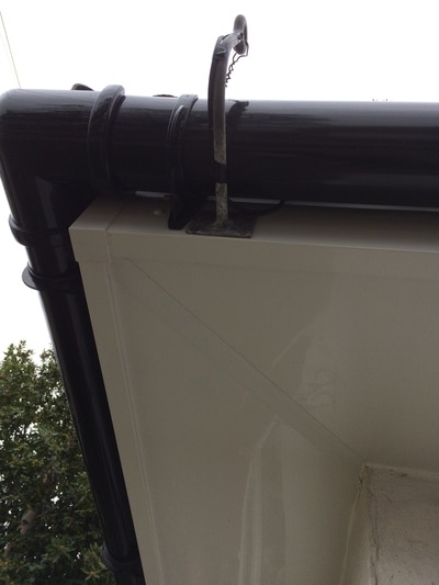 White fascia and soffit with black deep flow half round guttering  corner detail UPVC