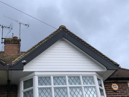 UPVC Black grain bargeboard ,fascia, guttering and white soffit,cladding in Ramsgate Thanet after replacement
