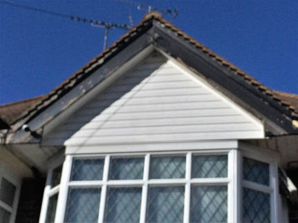 Black grain bargeboard ,fascia, guttering and white soffit,cladding in Ramsgate Thanet before replacement