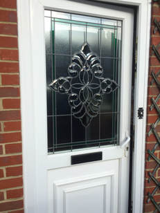 Residential UPVC double glazed door with special lead and bevelled glass design