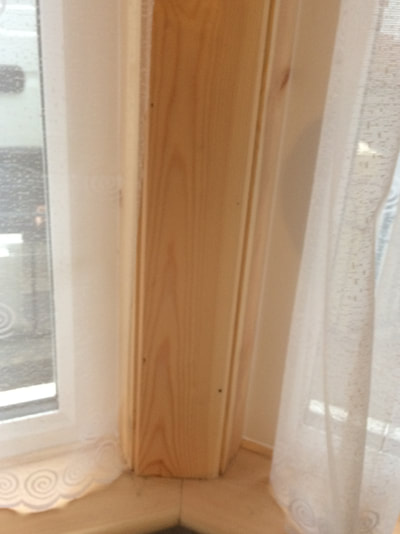 UPVC window with timber surround to internal pier