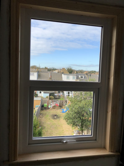 UPVC window with timber surround