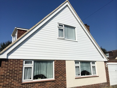 UPVC double glazed window with embossed woodgrain gladding and bargeboard