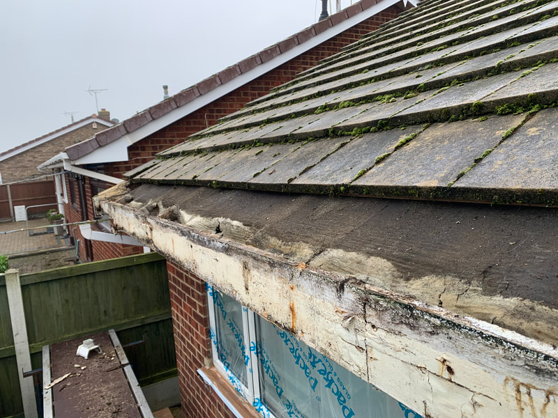 Plastic fascia removed showing rot beneath 